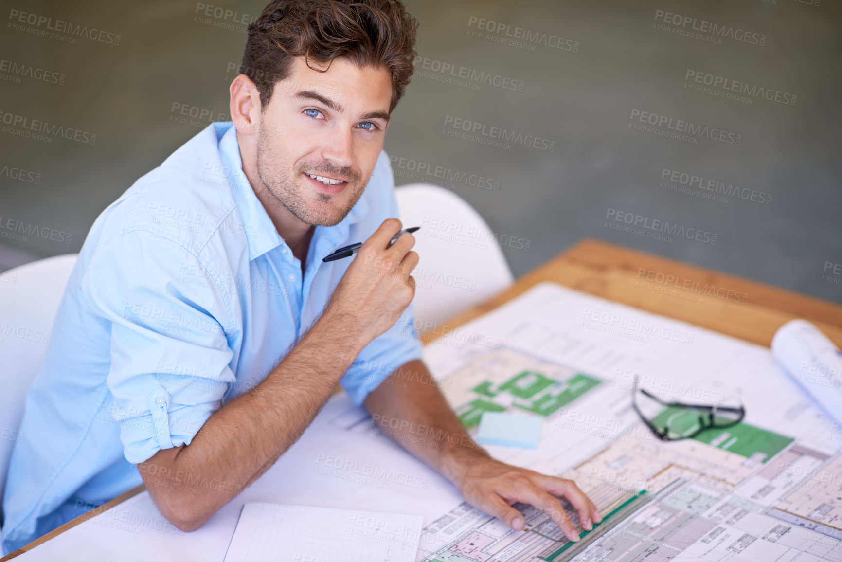 Buy stock photo Shot of a handsome architect working on his plans