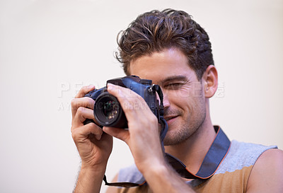 Buy stock photo Man, camera and photographer in studio for shooting, digital lens and tech for image or picture. Male person, hobby and equipment for photo on white background, production and capture for memories