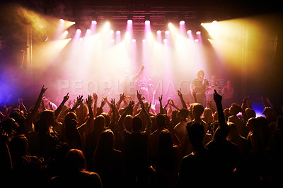 Buy stock photo Festival, music and concert with energy of crowd cheering for live rock band on stage. Event, fans and happy people cheer for energetic performance at music festival in Los Angeles, USA.