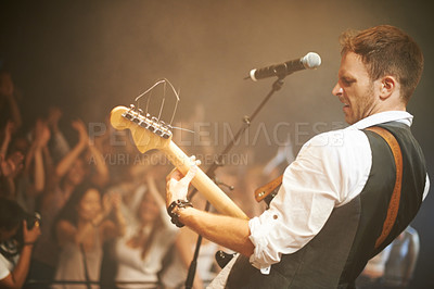 Buy stock photo Man, musician or playing guitar at live band concert, nightclub event or party show for diversity crowd, people or friends. Guitarist, stage artist and microphone for audience dance floor at festival