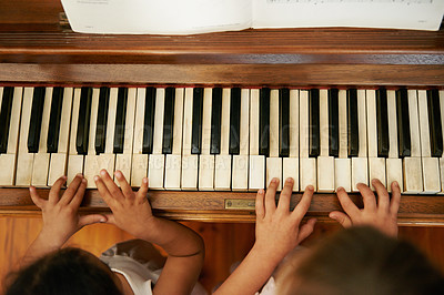 Buy stock photo High angle view of two little girls playing a duet on the piano