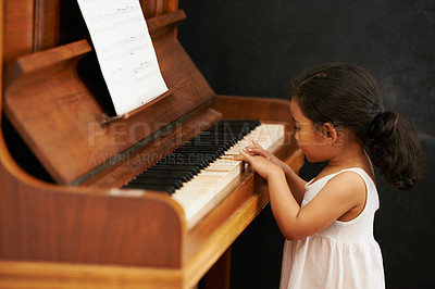 Buy stock photo Piano, kid and toddler in home for learning, practice and classical education with musical notes. Training, melody and girl with talent, creative or hobby with instrument, child development or skill