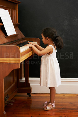 Buy stock photo Piano, girl and toddler in home for learning, practice and classical education with musical notes. Training, melody and kid with talent, creative or hobby with instrument, child development or skill