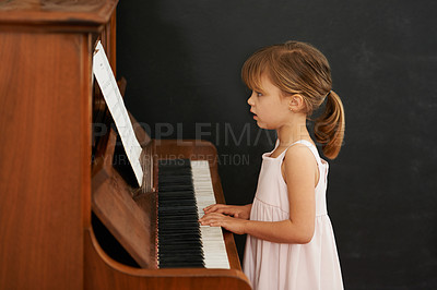 Buy stock photo Piano, reading and kid in home for learning, practice and classical education with musical notes. Training, melody and girl with talent, creative or hobby with instrument, child development or skill
