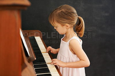 Buy stock photo Piano, playing and kid in home for learning, practice and classical education with musical notes. Training, melody and girl with talent, creative or hobby with instrument, child development or skill