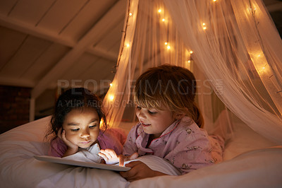 Buy stock photo Bed, night and girls with a tablet, movie and playing games with happiness, online reading and relax. Female children, happy kids and young people in a bedroom, evening and technology for fun and app