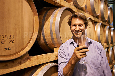Buy stock photo Portrait, smile and wine tasting with a man in the cellar of a distillery on a farm for the production of alcohol. Glass, industry and barrel with a happy male farmer drinking for quality control