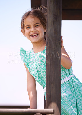 Buy stock photo Portrait, smile and child at playground outdoor in summer for fun on vacation with cute, adorable and innocent girl. Playing, happy and kid at jungle gym, funny and laughing for joy alone in Spain
