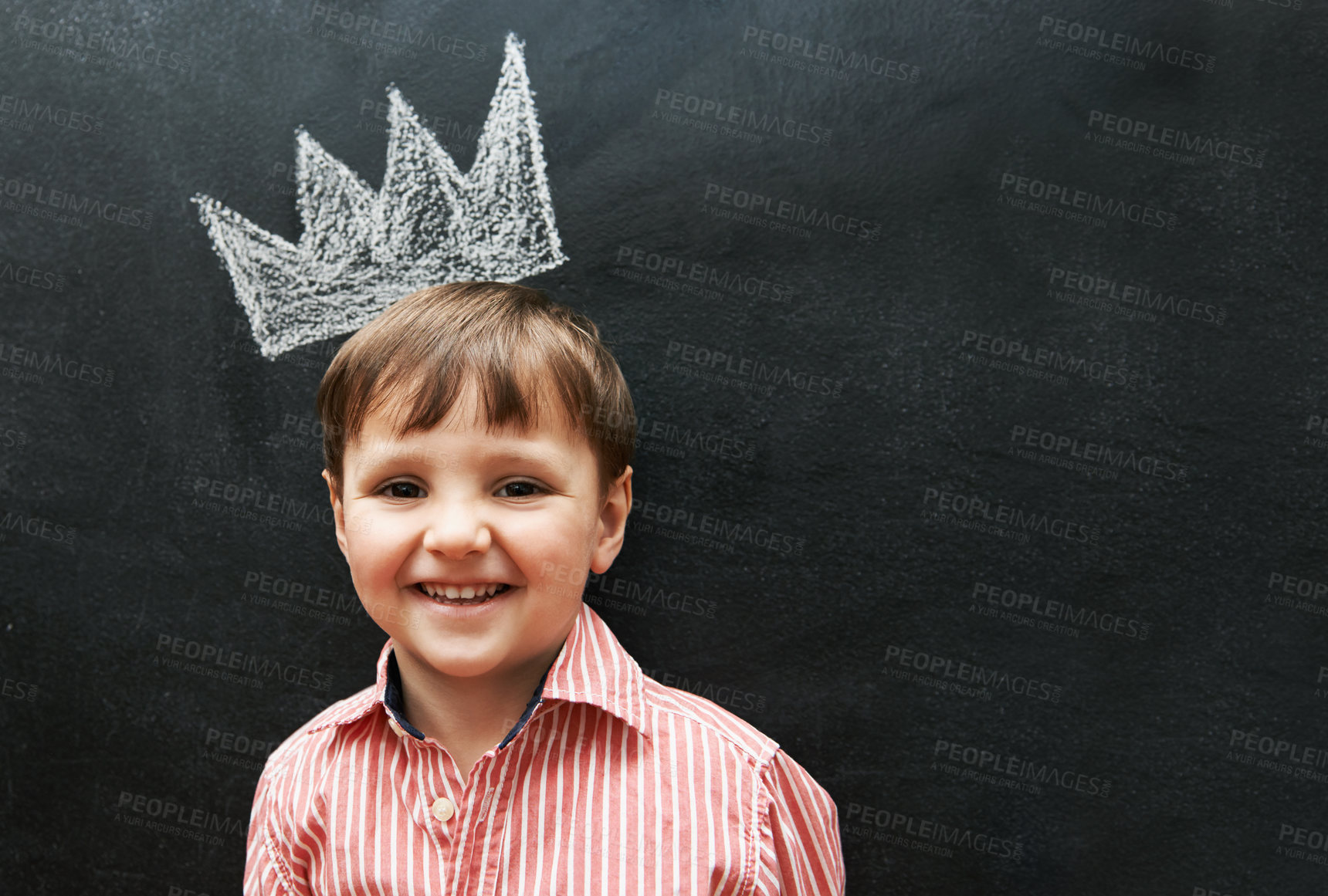 Buy stock photo Boy, portrait and crown on chalkboard with smile from cute learner in preschool. Young student, happy and learning in classroom for education in art for development of creativity for youth 