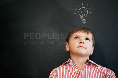 Buy stock photo Studio shot of a young boy with a chalk-drawing light bulb above his head