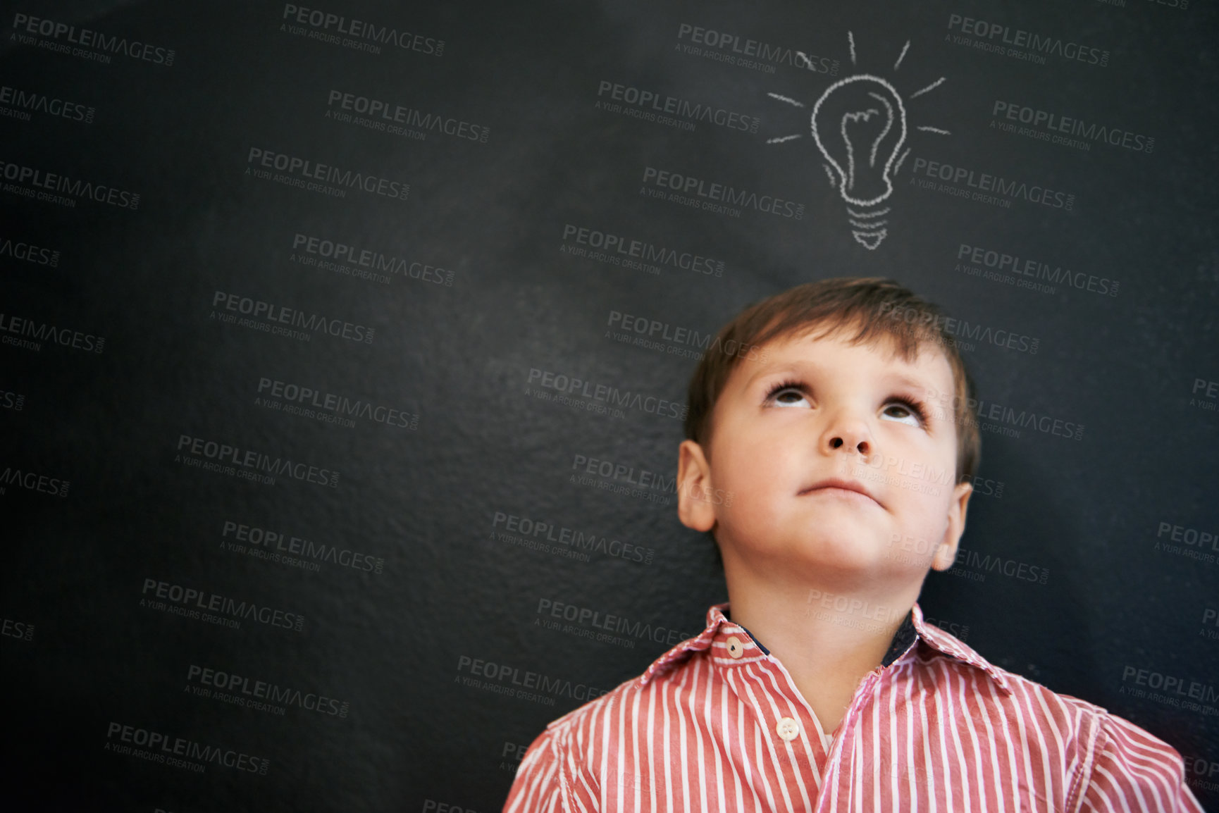 Buy stock photo Studio shot of a young boy with a chalk-drawing light bulb above his head