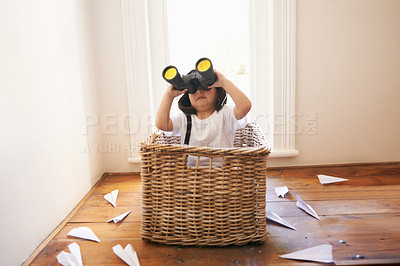 Buy stock photo Binoculars, paper plane and child playing with adventure, imagination and fun in basket at home. Fantasy, little pilot and playful boy in box with future dream, growth and development with airplane