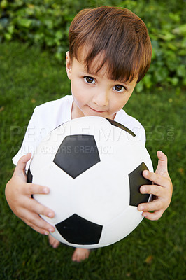 Buy stock photo Portrait, kid and play with football in garden for fun, healthy and childhood development in Brazil. Closeup, sweet and young boy with soccer ball for afternoon game or exercise in backyard or park