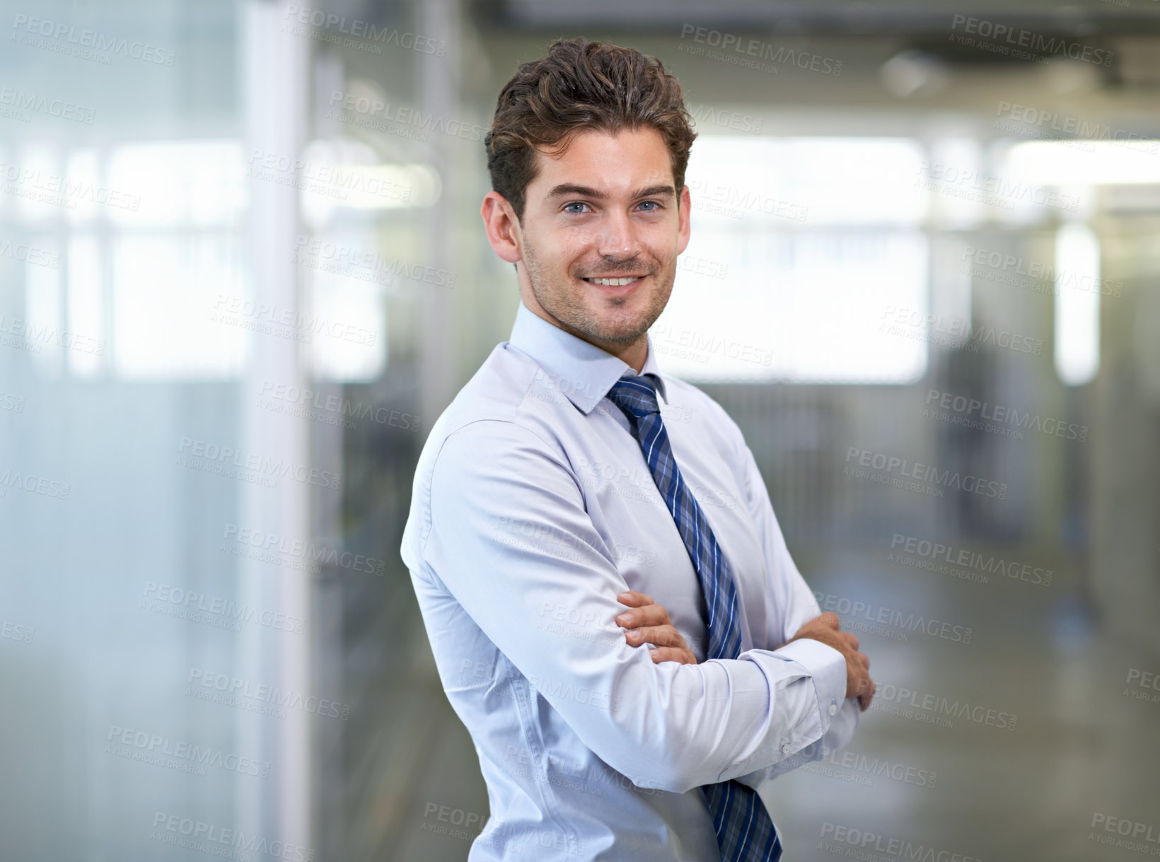 Buy stock photo Shot of a young businessman in a corporate office