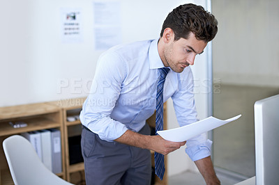 Buy stock photo Businessman, computer and paperwork online research or feedback review for internet, brainstorming or legal document. Male person, report and financial consultant for budget, accounting or investing