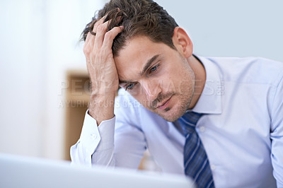 Buy stock photo A young businessman looking frustrated at the office
