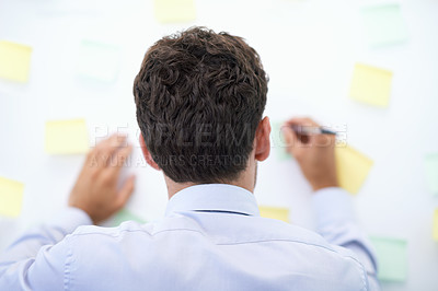 Buy stock photo Businessman, writing and sticky notes on wall for planning, brainstorming and project reminder with rear view. Entrepreneur, employee and ideas for agenda, schedule and proposal information at work