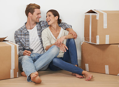 Buy stock photo New property, boxes and happy couple for moving with mortgage and excited for investment in real estate. Man, woman and proud homeowner with love hug in home and funny joke in house in living room