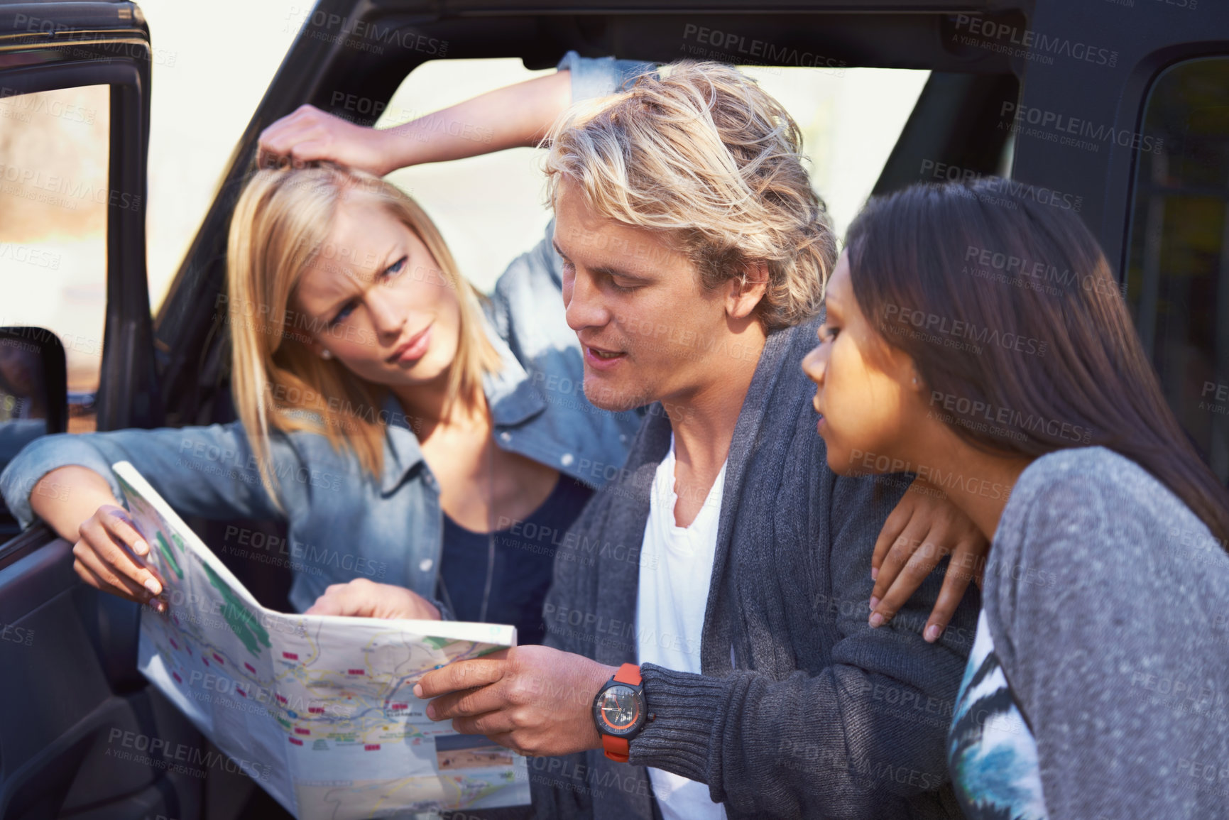 Buy stock photo Group of friends, outdoor and map for adventure, travel and lost with journey and getaway trip. Lost, man and women with paper and searching for a place with conversation and discussion with vehicle