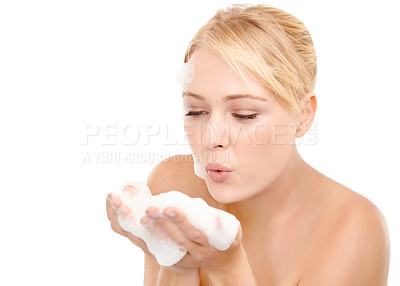 Buy stock photo Skincare, foam and woman blowing bubbles in studio for cleaning, cosmetics or wellness on white background. Hands, soap and female model relax with beauty, treatment or facial, wash and application