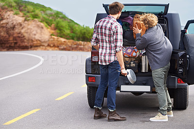 Buy stock photo Shot of a two people stopped at the side of the road and repacking their truck