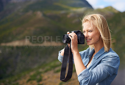 Buy stock photo Happy woman, blonde and camera for outdoor photography, picture or sightseeing on mountain. Young female person or journalist with smile for photo, view or memory in natural environment in nature