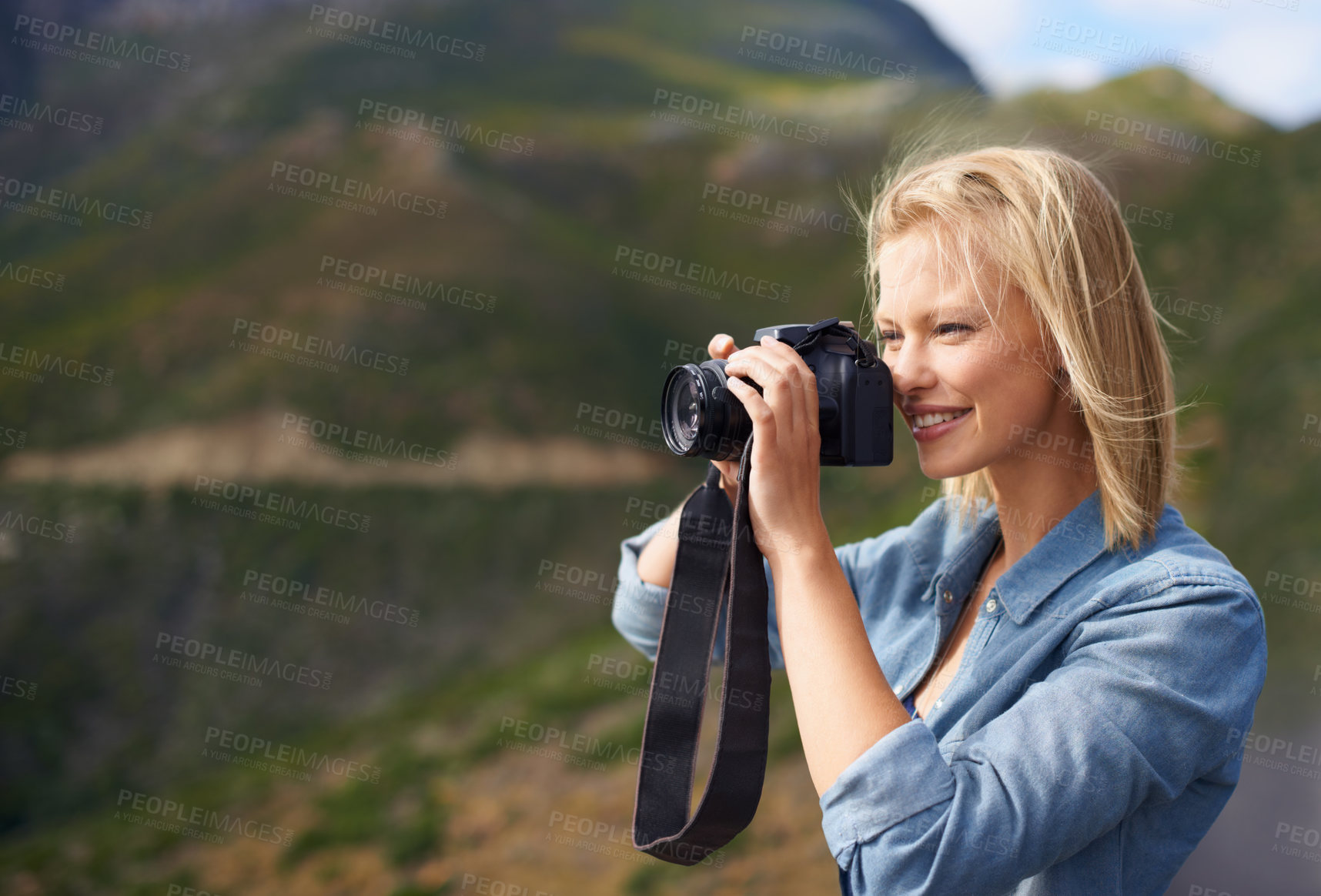 Buy stock photo Happy woman, blonde and camera for outdoor photography, picture or sightseeing on mountain. Young female person or journalist with smile for photo, view or memory in natural environment in nature