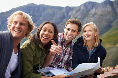 Buy stock photo Happy people, friends and pointing with map for travel, location or destination on mountain in nature. Young group with smile, document or geographic paper for navigation, help or outdoor tourism