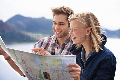 Buy stock photo Happy people, friends and pointing to map for location, travel or destination on mountain in nature. Young couple with smile, document or paper with routes for navigation, help or outdoor tourism