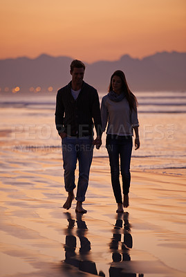 Buy stock photo Couple, holding hands and walking on beach for sunset, nature and travel with bonding for love and commitment outdoor. People, trust and loyalty with adventure together for honeymoon or anniversary