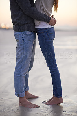 Buy stock photo Couple, legs and hug at beach on vacation, love and care with feet in sand in nature, outdoor and ocean. Man, woman and embrace on date, bonding and sunset for memory on holiday by sea in Australia