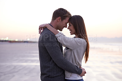 Buy stock photo Love, hug and couple on beach in evening for tropical holiday adventure, relax and bonding together. Commitment, happy man and woman on romantic date with ocean, sunset sky and embrace on vacation.