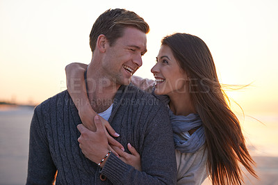 Buy stock photo Love, laugh and couple on beach at sunset for tropical holiday adventure, relax and bonding together. Commitment, happy man and woman on romantic date with ocean, evening sky and embrace on vacation.