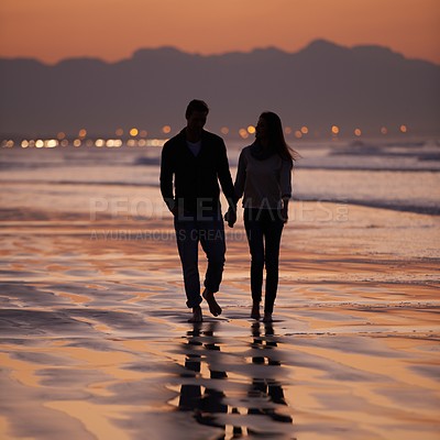 Buy stock photo Silhouette, sunset and couple holding hands outdoor with back view and nature, travel and bonding for love and commitment. People walk on beach, trust and loyalty with adventure together and shadow