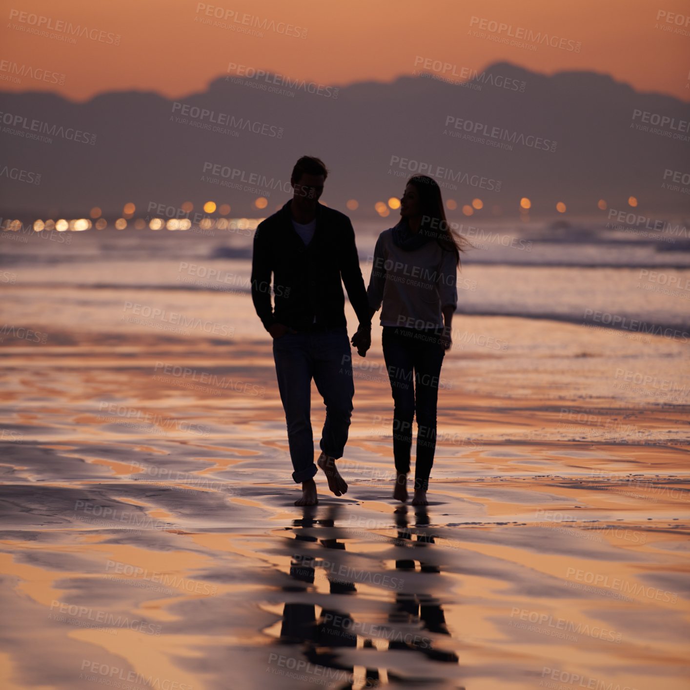 Buy stock photo Silhouette, sunset and couple holding hands outdoor with back view and nature, travel and bonding for love and commitment. People walk on beach, trust and loyalty with adventure together and shadow