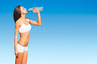 Buy stock photo Fitness, woman and drinking water on mockup space for hydration after workout, exercise or training on blue sky. Thirsty, active and fit female with drink bottle for healthy body, wellness or hydrate