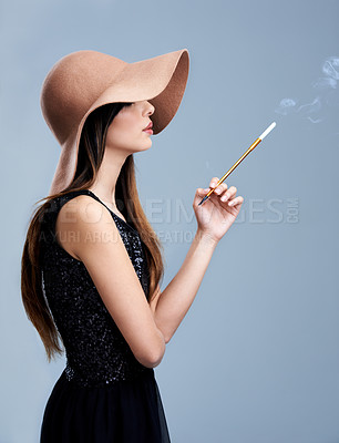 Buy stock photo Glamour, profile and woman in hat with cigarette, confidence and vintage fashion in studio. Classic, chic and elegant style with girl smoking on grey background in designer clothes with aesthetic.