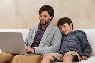 Buy stock photo A young boy and his father using a laptop
