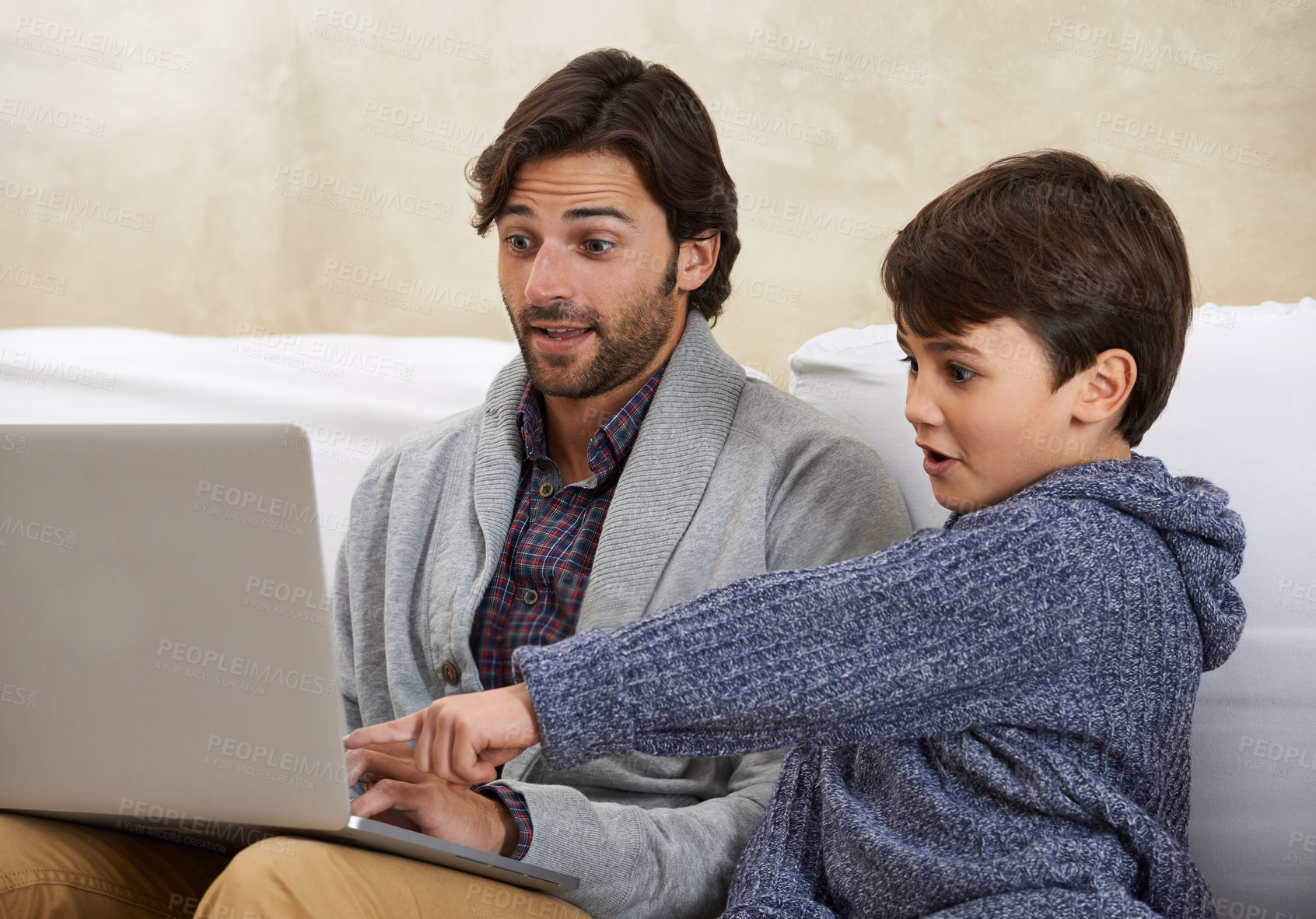 Buy stock photo A young boy and his father playing on a laptop