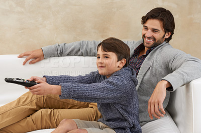 Buy stock photo Remote, TV and father and child on sofa together for bonding, relationship and relax in living room. Family, parents and dad with young son for cartoon, watching movies and entertainment in home