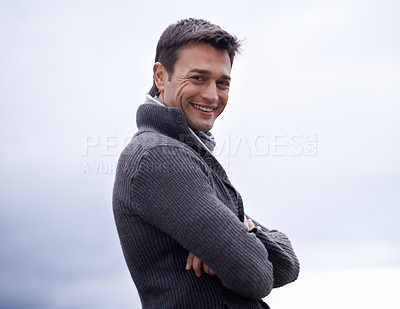 Buy stock photo Man, portrait and happy with arms crossed or sky for relax, travel and winter adventure on holiday or vacation. Person, tourist and face with smile in nature or outdoor for fresh air and wellness
