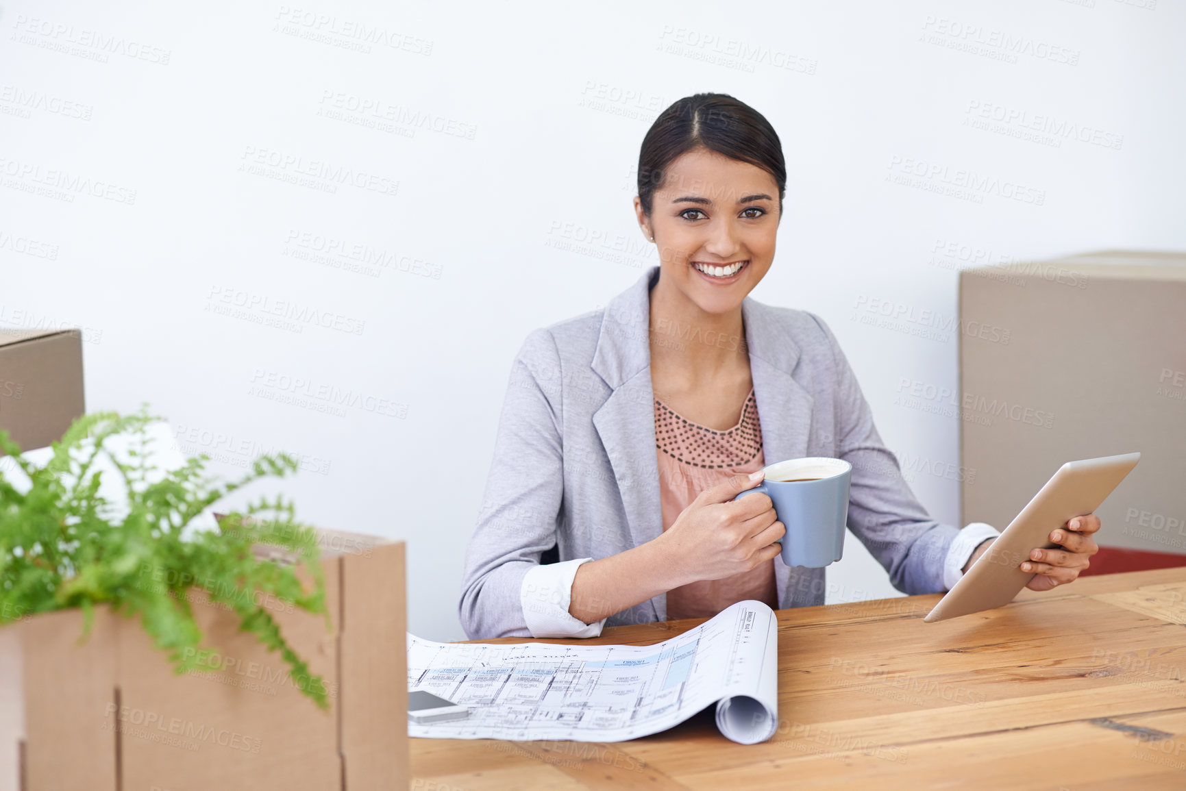 Buy stock photo Shot of a young designer happily at work on her tablet