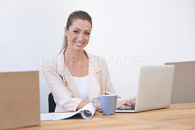 Buy stock photo Shot of a young designer happily at work on her laptop