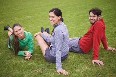 Buy stock photo Fitness, friends and portrait of people in field ready for practice, playing game and match outdoors. Happy, sports and man and women rest on grass for training, exercise and workout for wellness