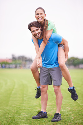 Buy stock photo Couple, piggy back and exercise in park with portrait, smile and bonding with health in nature on grass. People, man and woman with care, support and laughing on lawn for training together in England