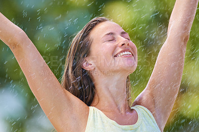 Buy stock photo Woman, rain and freedom with a smile from spring climate, water and weather outdoor in a park. Happy, travel and female person excited on holiday and vacation with hands up from joy in nature