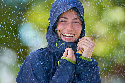 Buy stock photo Woman, rain and portrait with laughing from winter climate, water and weather outdoor in a park. Happy, travel and female person with jacket for cold on holiday and vacation with raincoat and joy