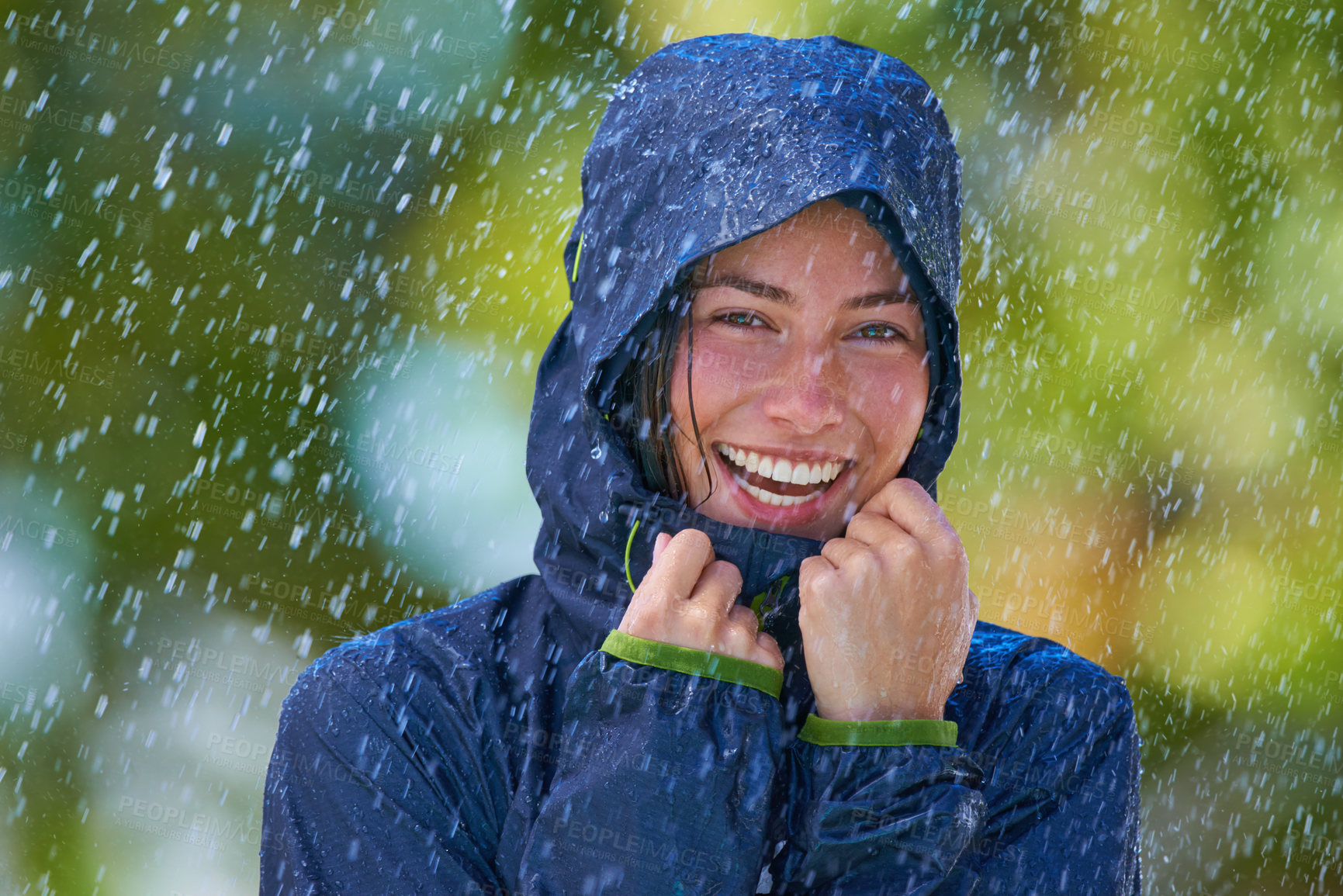 Buy stock photo Cropped shot of a young woman standing happily in the rain