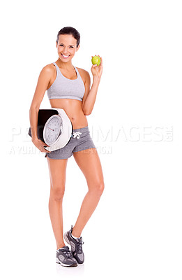 Buy stock photo Portrait if a sporty young woman holding a scale while eating an apple