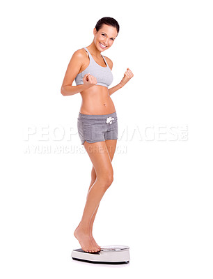 Buy stock photo Full-length shot of an attractive and sporty young woman standing on a scale